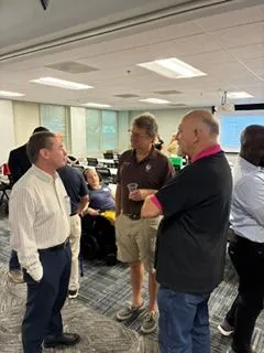 Small group standing and talking at a networking seminar