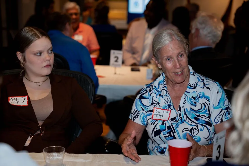 Two generations connecting at a community networking event